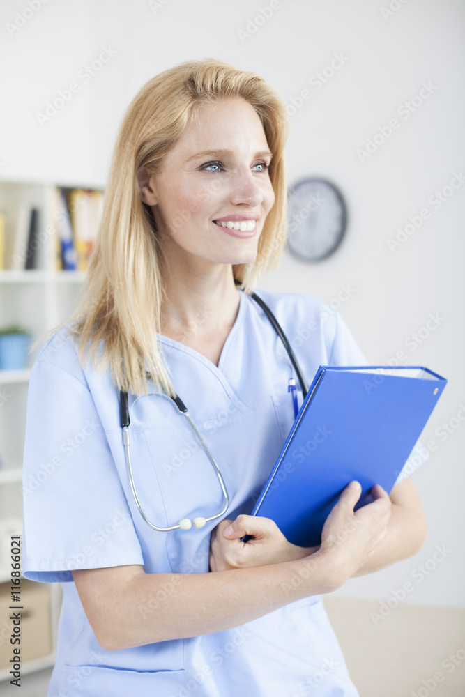 Young female doctor and practitioner working at desk
Young female doctor and practitioner working at desk