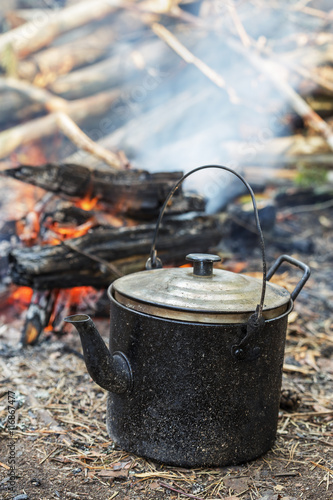 old iron kettle on fire. Cooking food in field conditions