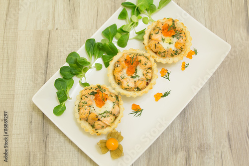 Salmon baked tartlet with mozzarella on a white plate photo