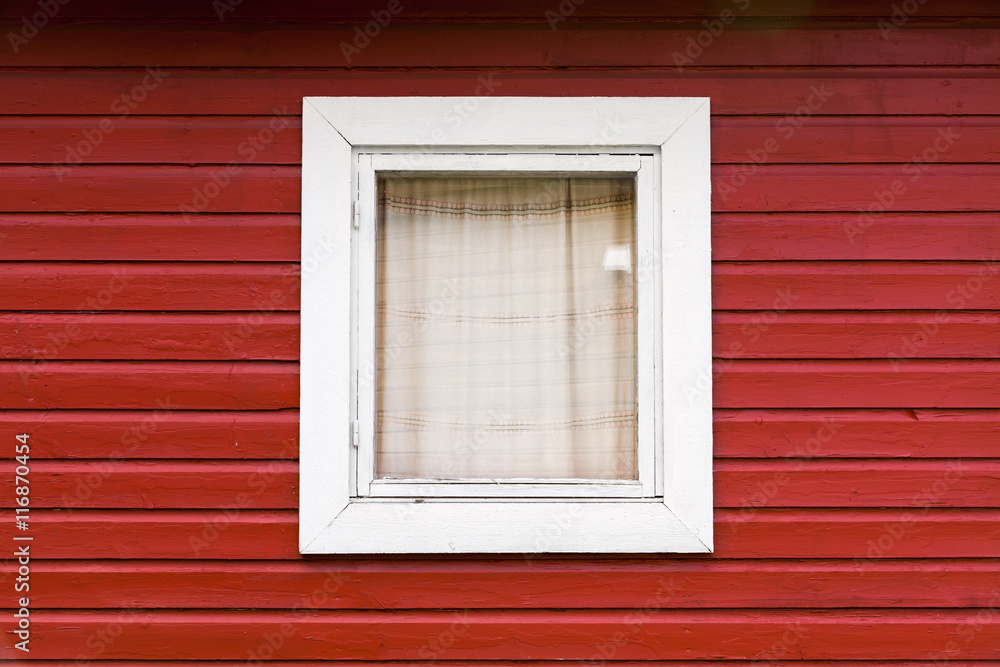 Red wooden wall with small window
