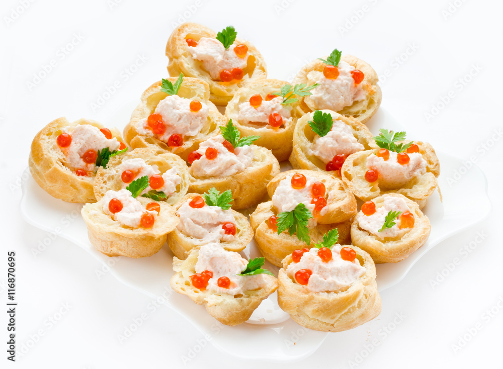 Profiteroles with mousse or pate and red caviar on white background Profiteroles with mousse or pate and red caviar on white background
