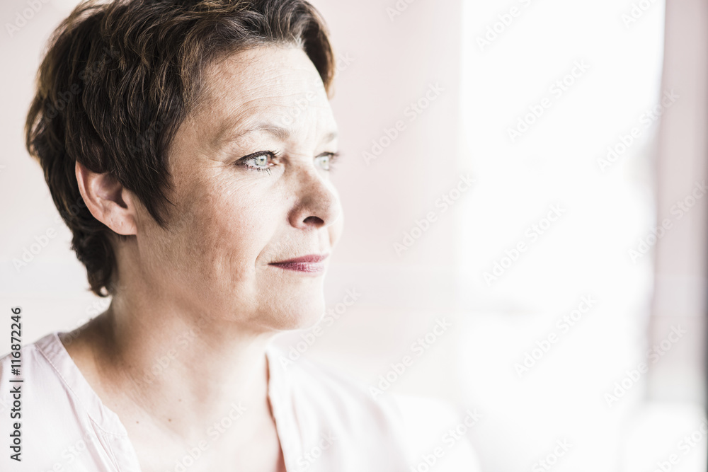 Portrait of pensive businesswoman looking through window Portrait of pensive businesswoman looking through window