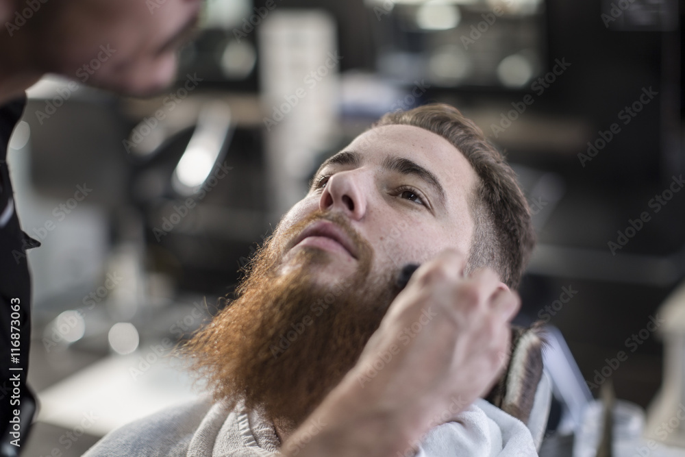 Barber brushing customers side hairs Barber brushing customers side hairs