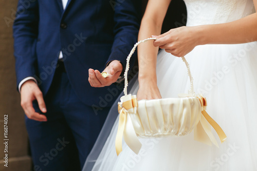 Bride holds a little basket with sweets