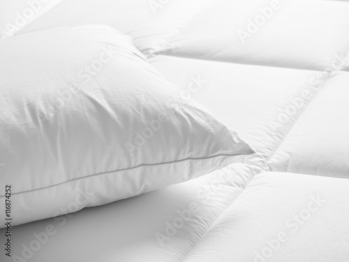 Closeup of white pillow on the bed in the bedroom