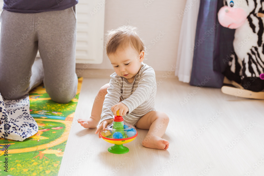 baby boy playing with toy indoors at home baby boy playing with toy indoors at home