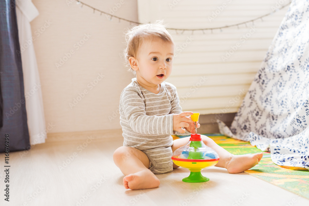 baby boy playing with toy indoors at home baby boy playing with toy indoors at home