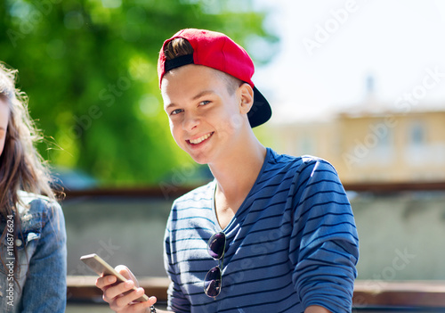 happy teenage boy with smartphone outdoors © Syda Productions