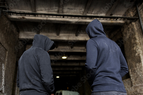addict men or criminals in hoodies on street