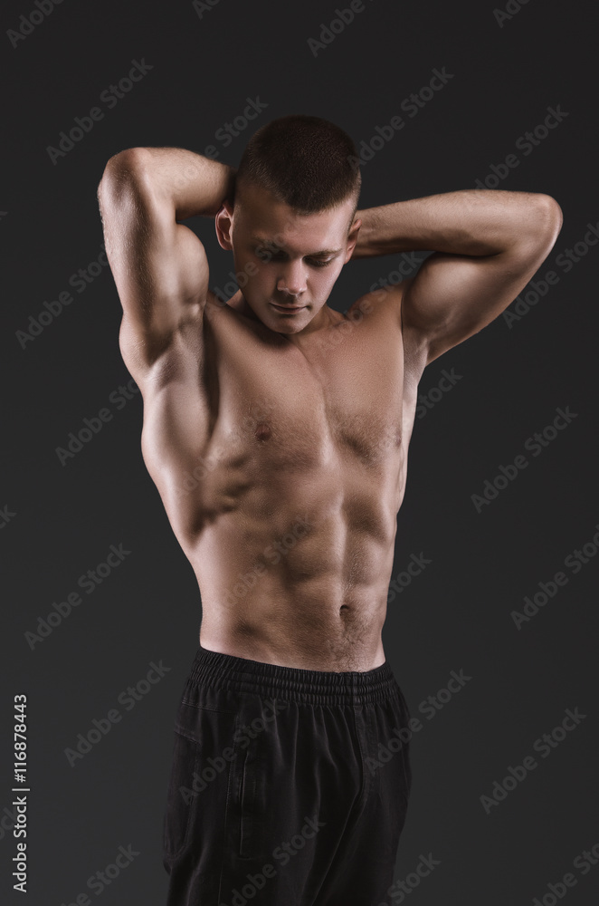 Healthy muscular young man posing.  Sport portrait.