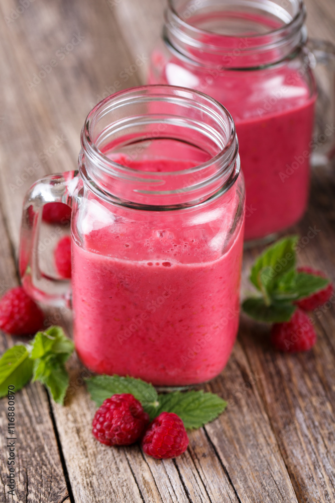 Tasty raspberry smoothie on wooden table. Tasty raspberry smoothie on wooden table.