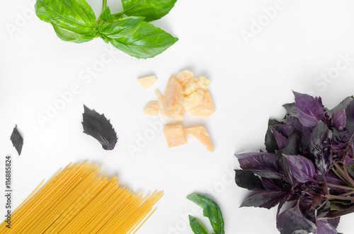 Spaghetti basil and parmesan cheese on a white table photo