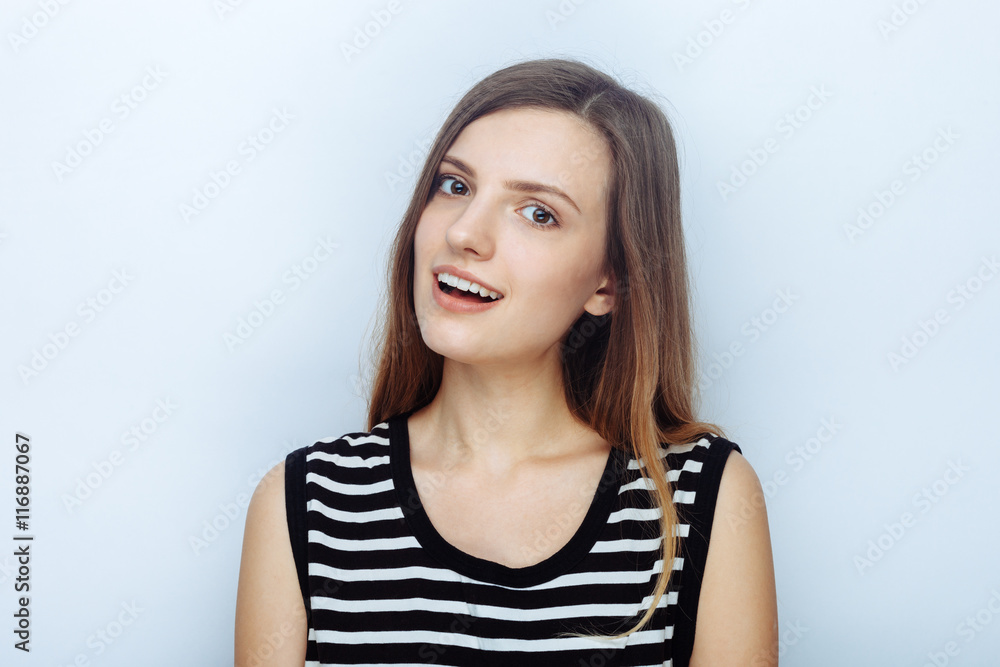 Portrait of happy young beautiful woman in striped shirt posing for model tests against studio background Portrait of happy young beautiful woman in striped shirt posing for model tests against studio background