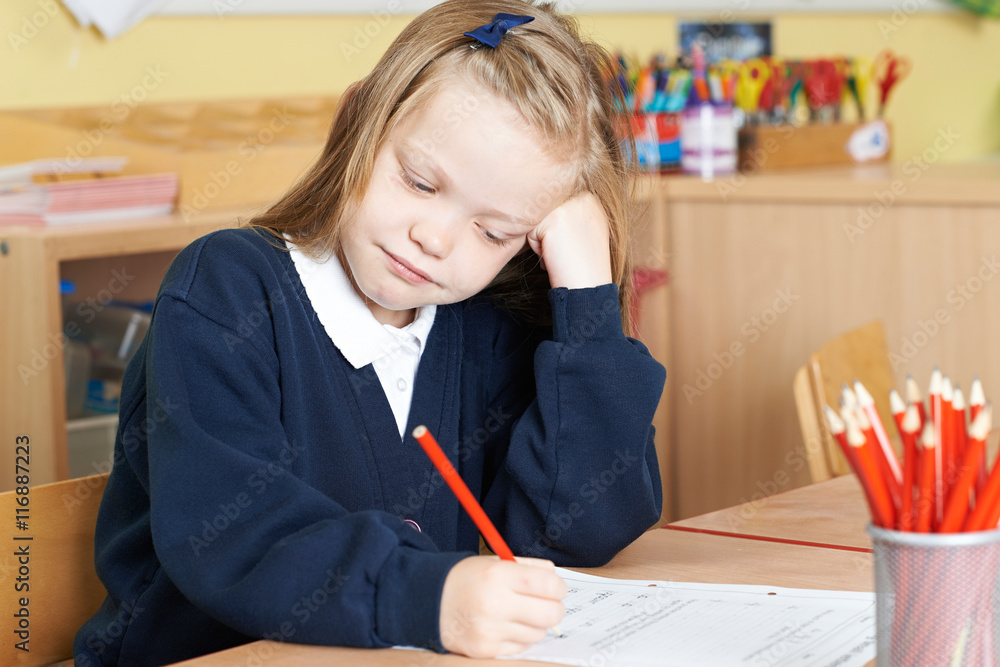 Bored Female Elementary School Pupil At Desk Bored Female Elementary School Pupil At Desk
