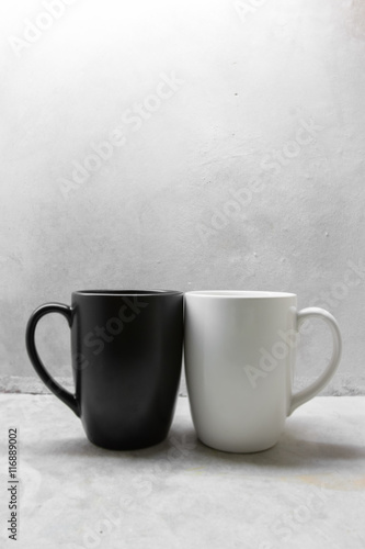 Black and white coffee mug on concrete table