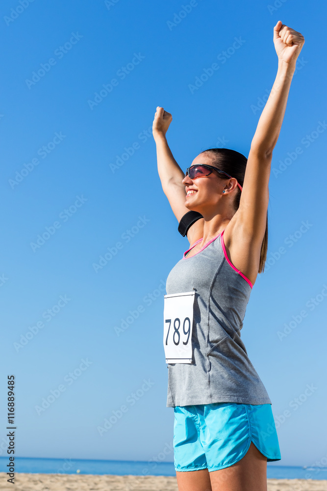 Female runner with start number showing winning attitude.