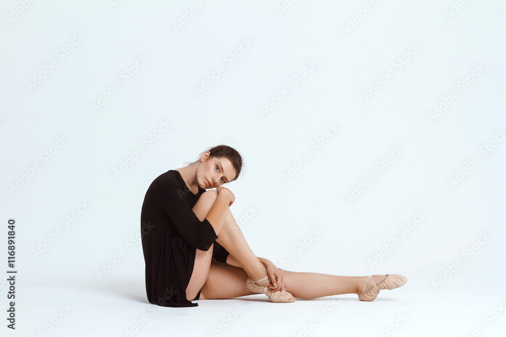 Young beautiful contemporary dancer posing over white background. Copy space. Young beautiful contemporary dancer posing over white background. Copy space.