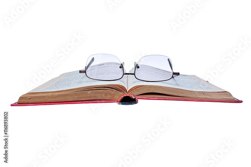 Old book and glasses isolated on white background