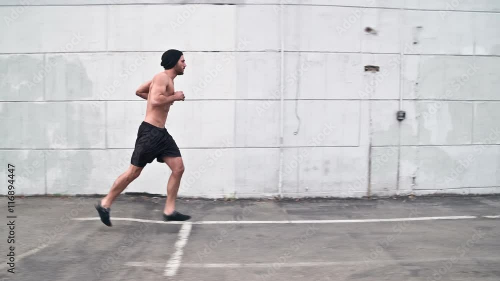 Athletic male working out in an empty parking lot. Crossfit. Slow Motion. Athletic male working out in an empty parking lot. Crossfit. Slow Motion.