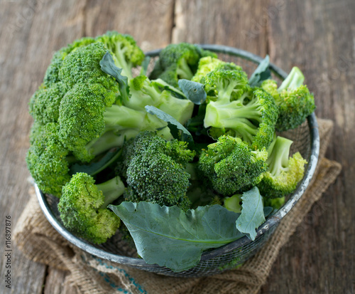 fresh broccoli on wooden surface