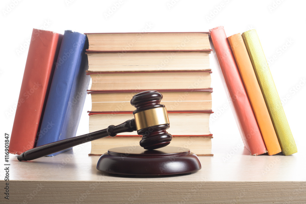 Law concept - Book with wooden judges gavel on table in a courtroom or enforcement office. Law concept - Book with wooden judges gavel on table in a courtroom or enforcement office.