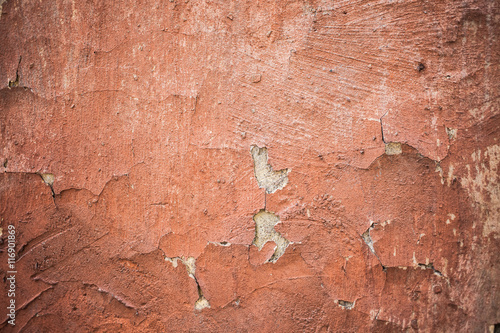 Old wall covered with paint plaster cracks