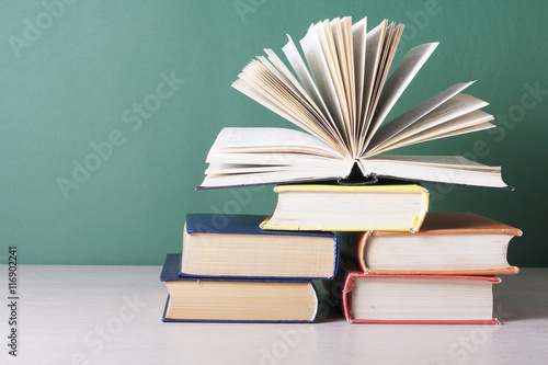 Open book, hardback books on wooden table. Education background. Back to school. Copy space for text.