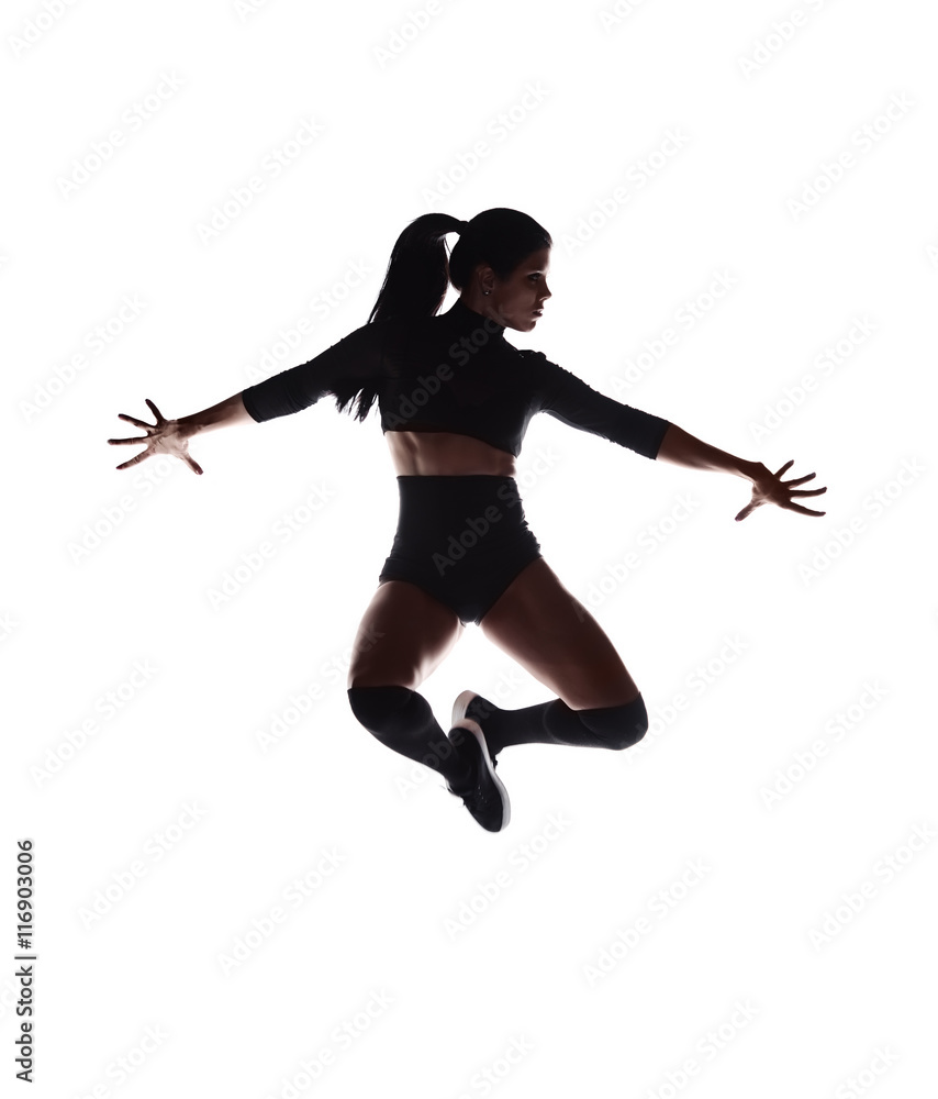 Silhouette of young sexy woman dancing on a white background