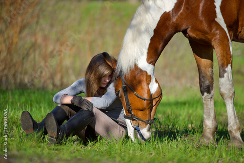 Girl sportswoman and her horse in the spring