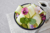Zucchini salad with edible flowers, summer vegan salad