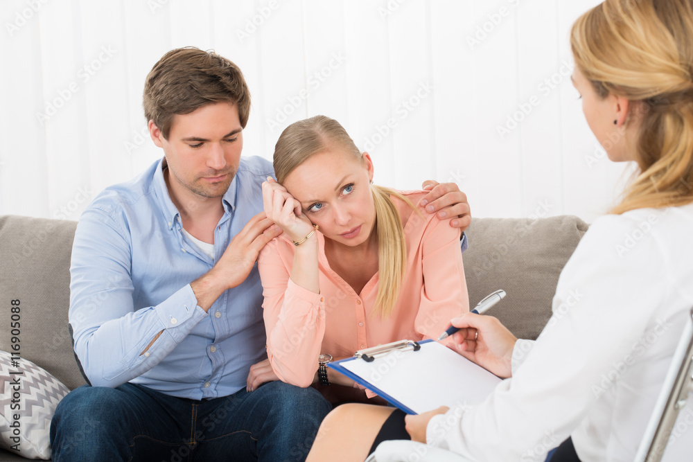 Sad Couple Sitting With Female Psychologist Sad Couple Sitting With Female Psychologist