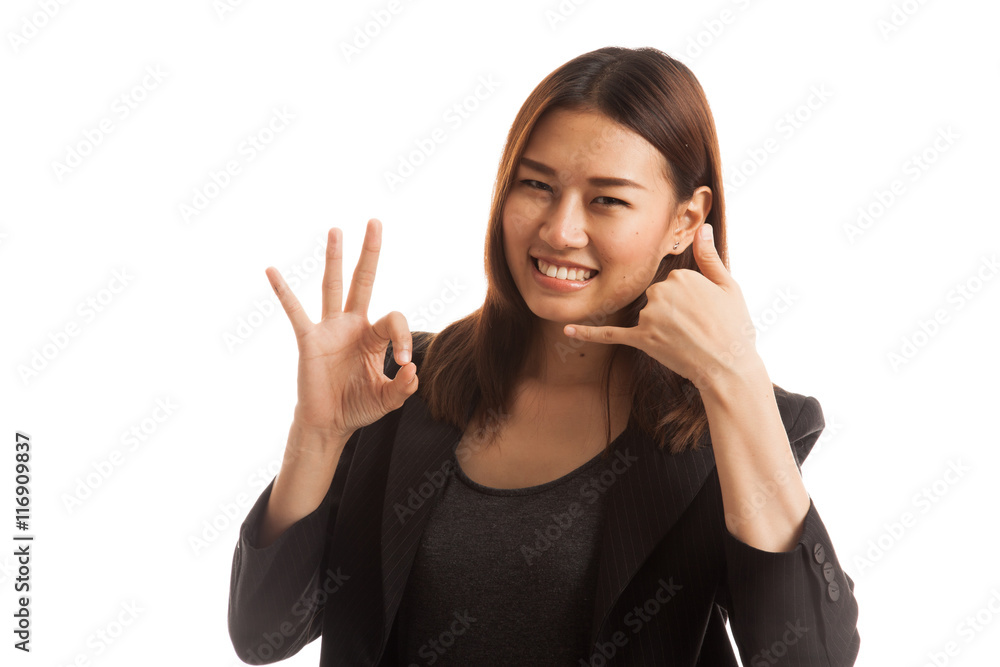 Young Asian woman show with phone gesture and OK sign. Young Asian woman show with phone gesture and OK sign.