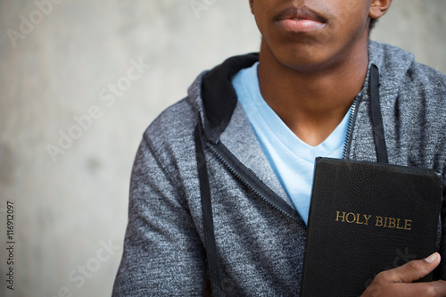 Young teen holding a Bible. Poster Mural XXL
