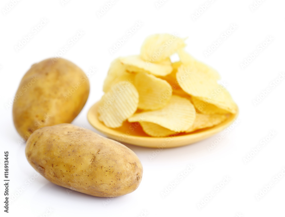 Potato and potato chips on wooden plate on white Potato and potato chips on wooden plate on white