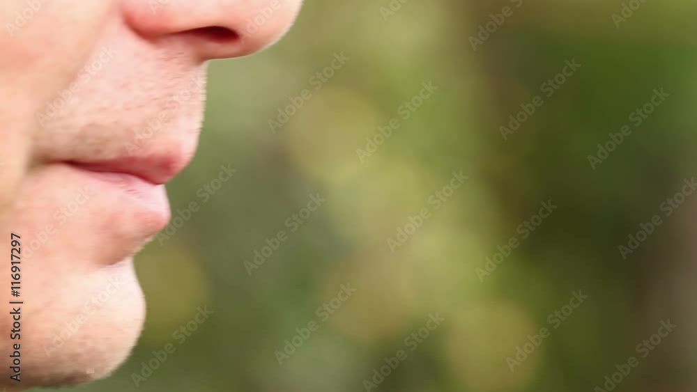 man smoking and talking. part of the face close-up man smoking and talking. part of the face close-up