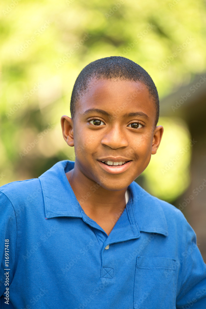 African American boy looking at the camera smiling and laughing. African American boy looking at the camera smiling and laughing.