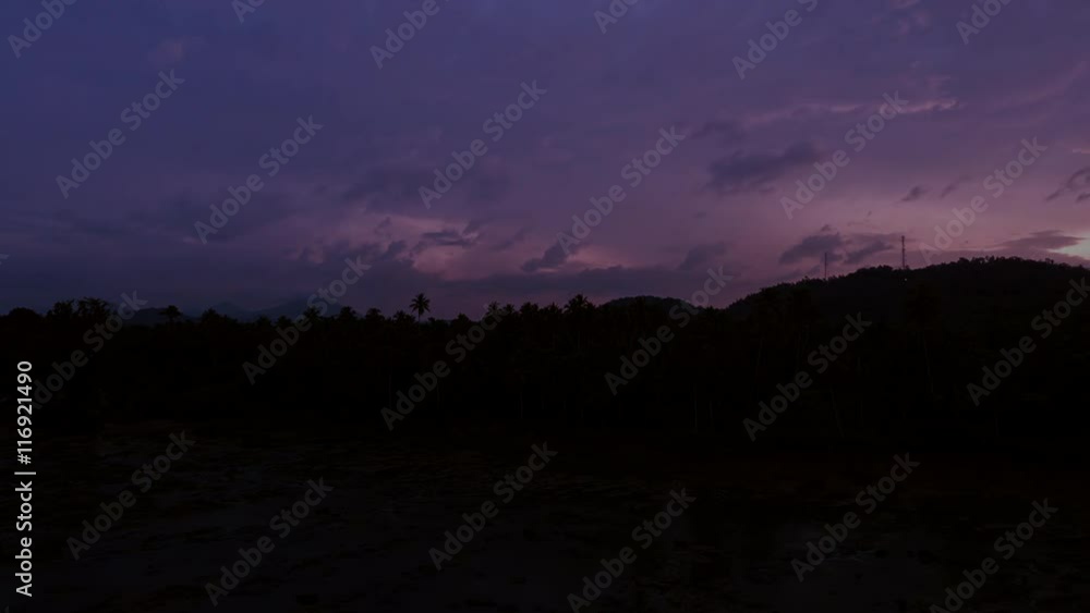 Scenic sunset timelapse in Sri Lanka. Evening clouds moving fast over palmtrees Scenic sunset timelapse in Sri Lanka. Evening clouds moving fast over palmtrees