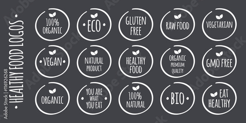 Vector white food logo on grey. 100% Organic, Eco, Gluten, GMO Free, Raw, Bio, Vegetarian, Vegan, Natural Product, Premium Quality, You are what you eat,  Eat Healthy symbols