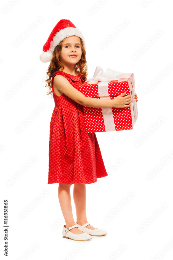 Cute girl in Santa hat hold huge present Cute girl in Santa hat hold huge present