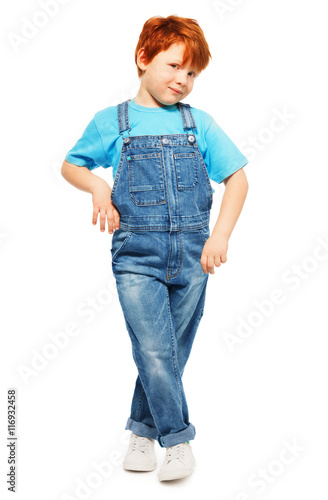 Cute redheaded boy in overall and blue t-shirt photo