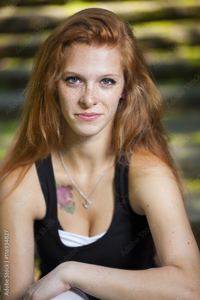 young red haired woman student relaxing learning in park sunny weather summer young red haired woman student relaxing learning in park sunny weather summer