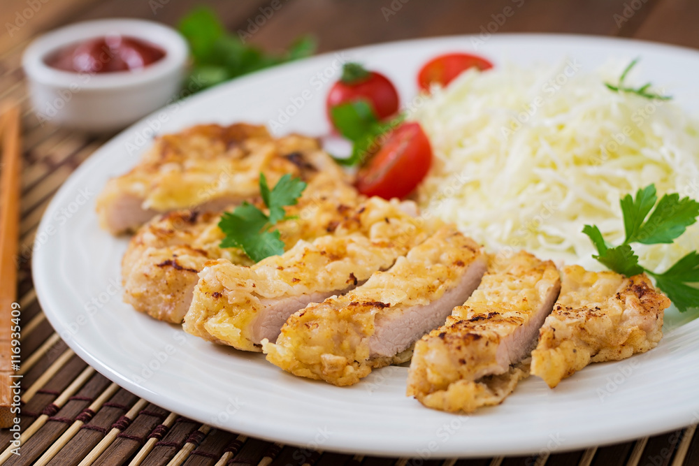 Fried pork cutlet with fresh cabbage salad and sauce Fried pork cutlet with fresh cabbage salad and sauce