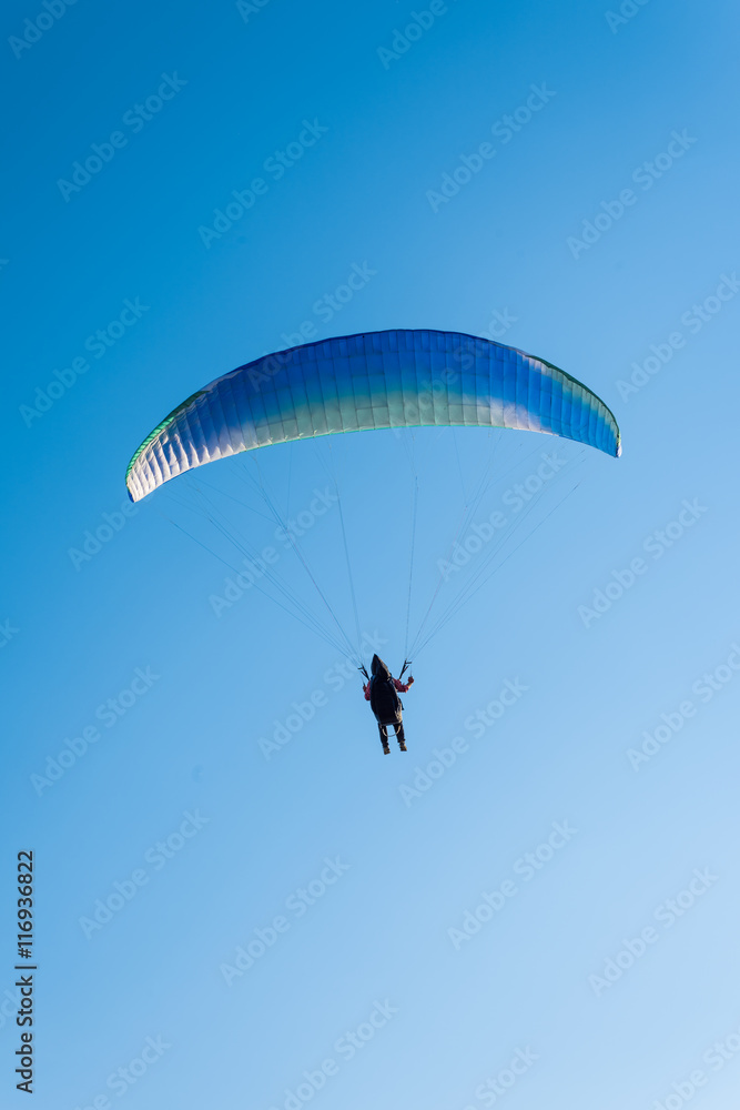 Paragliding in the sky. Man flying a paraglider on the sun. Paragliding in the sky. Man flying a paraglider on the sun.