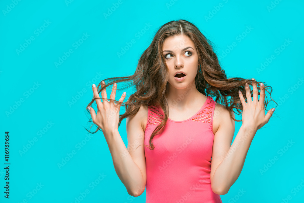 Portrait of young woman with shocked facial expression Portrait of young woman with shocked facial expression