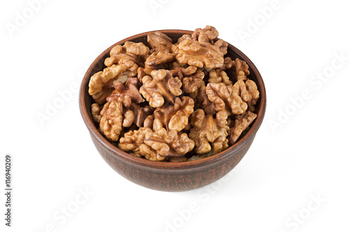 Walnuts shelled in a bowl isolated top view.