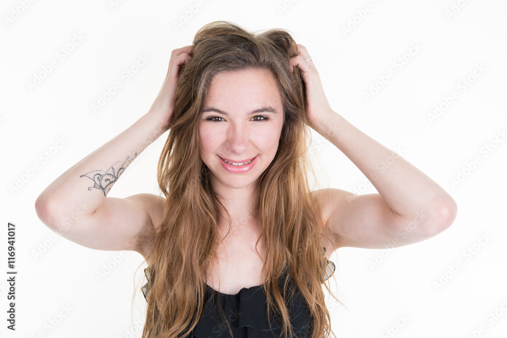 Beautiful blond woman with long hair touching her hair