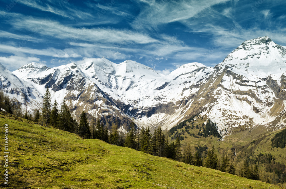 Beautiful view of Alps mountains. Spring in National Park Hohe Tauern, Austria. Green valley and snowy mountains peaks. Grossglockner high alpine road.