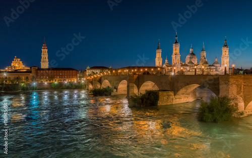 Basilica Our Lady Pillar In Zaragoza And the Bridge In Spain At Night