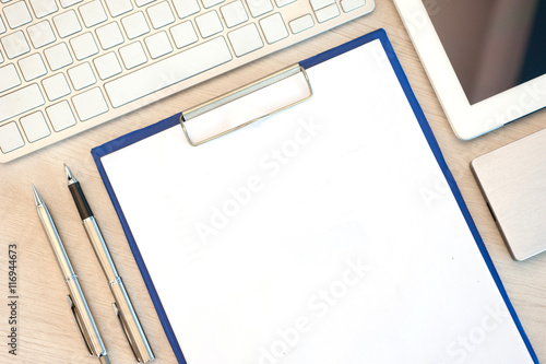 blank notepad and laptop in the office photo