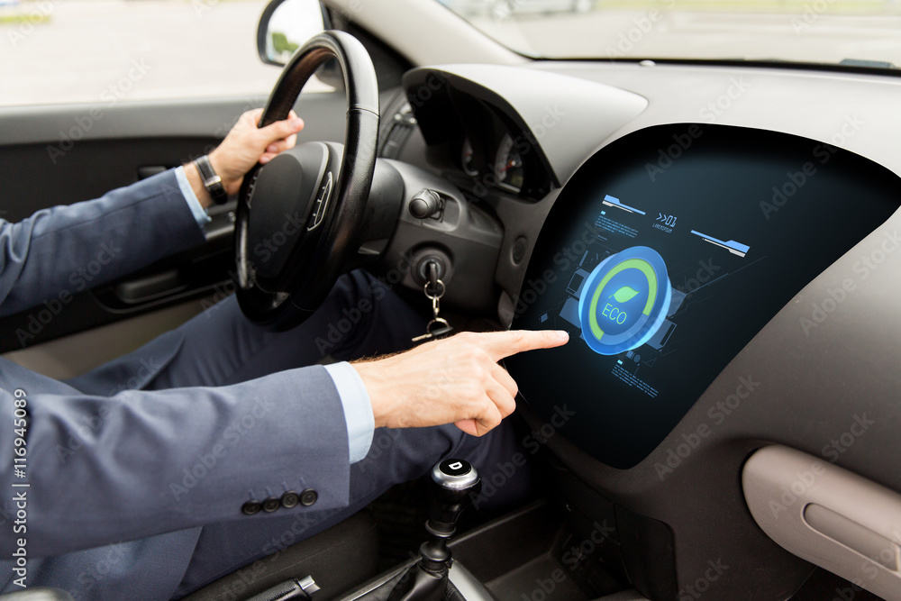 man driving car with eco mode on board computer man driving car with eco mode on board computer